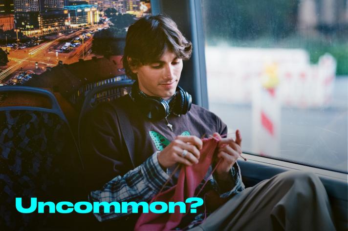 A boy knitting in a bus with caption 'Uncommon?'