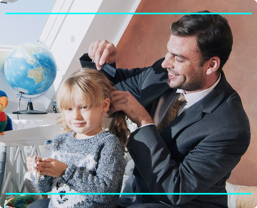Young girl with blonde hair getting her hair combed by her father.